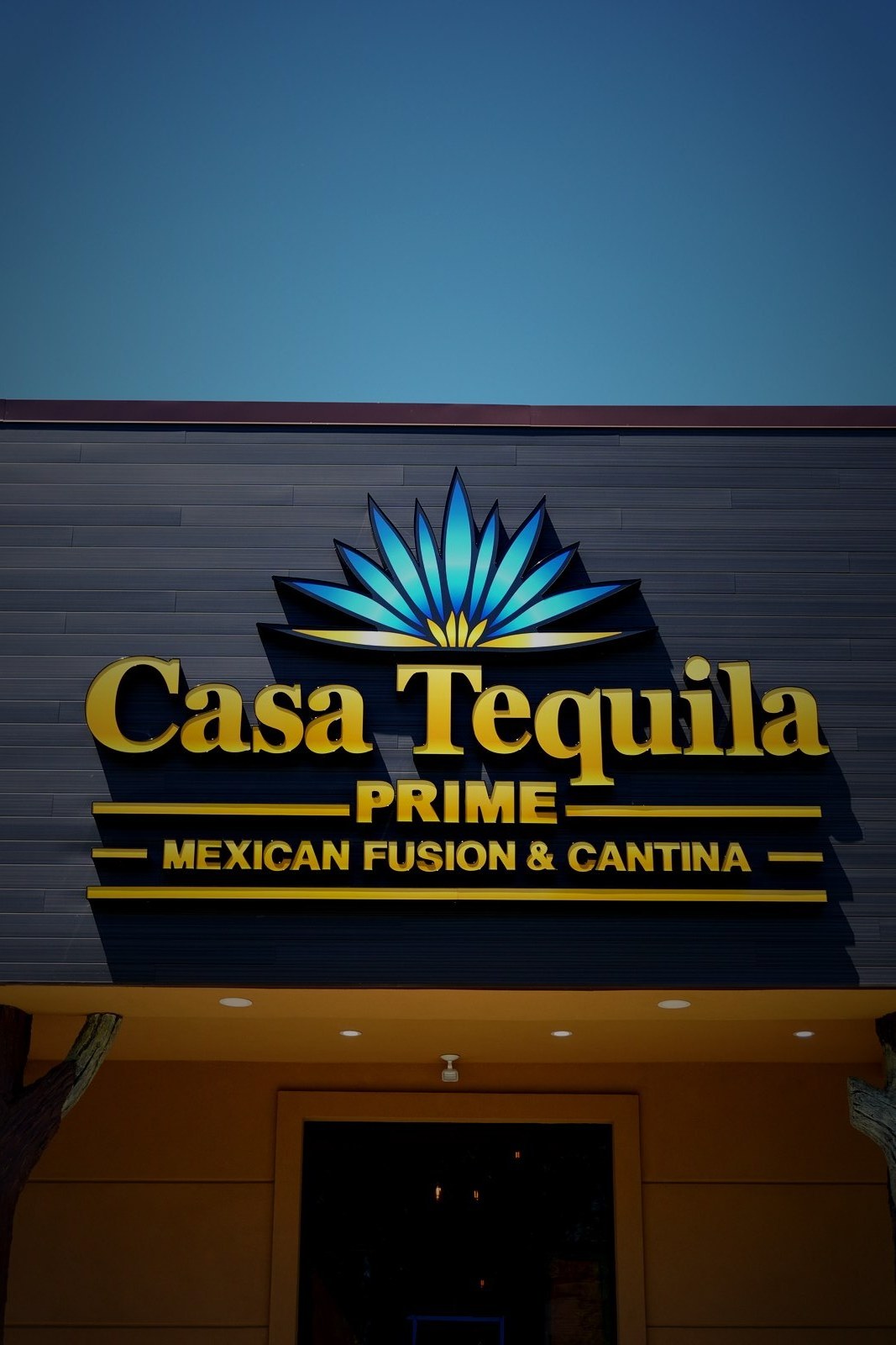 Casa Tequila Prime close-up exterior signage — gold lettering and blue agave emblem
